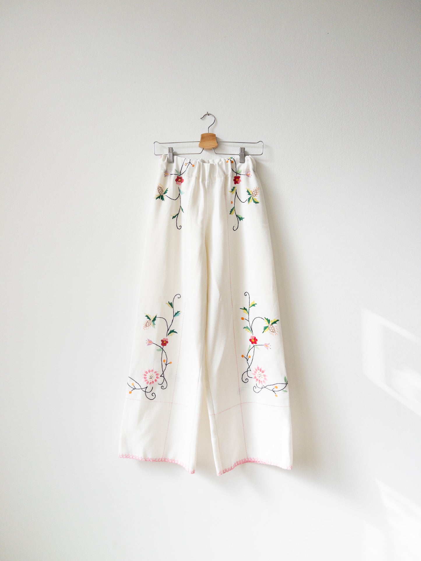 White pants with pink embroidery