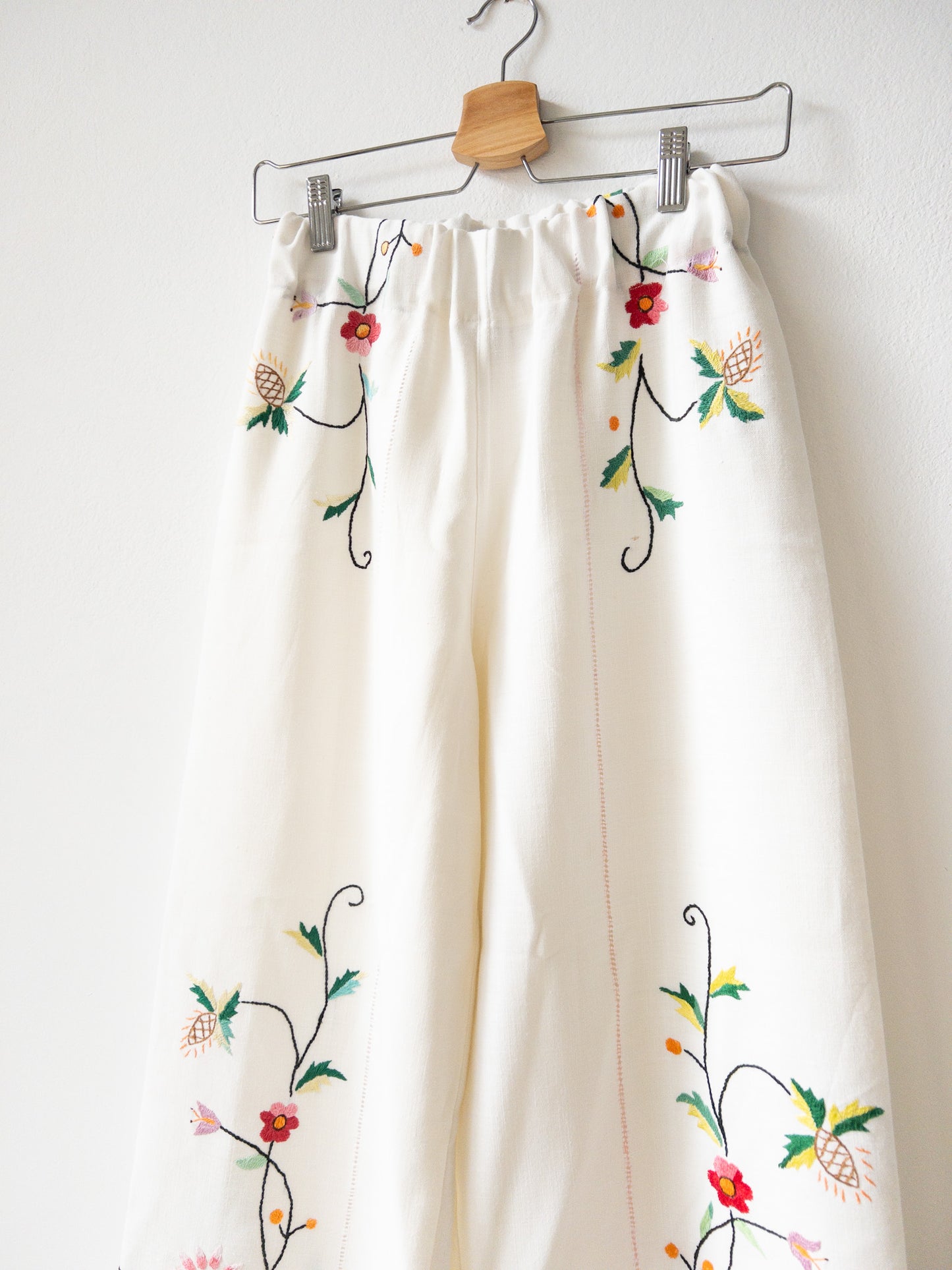 White pants with pink embroidery