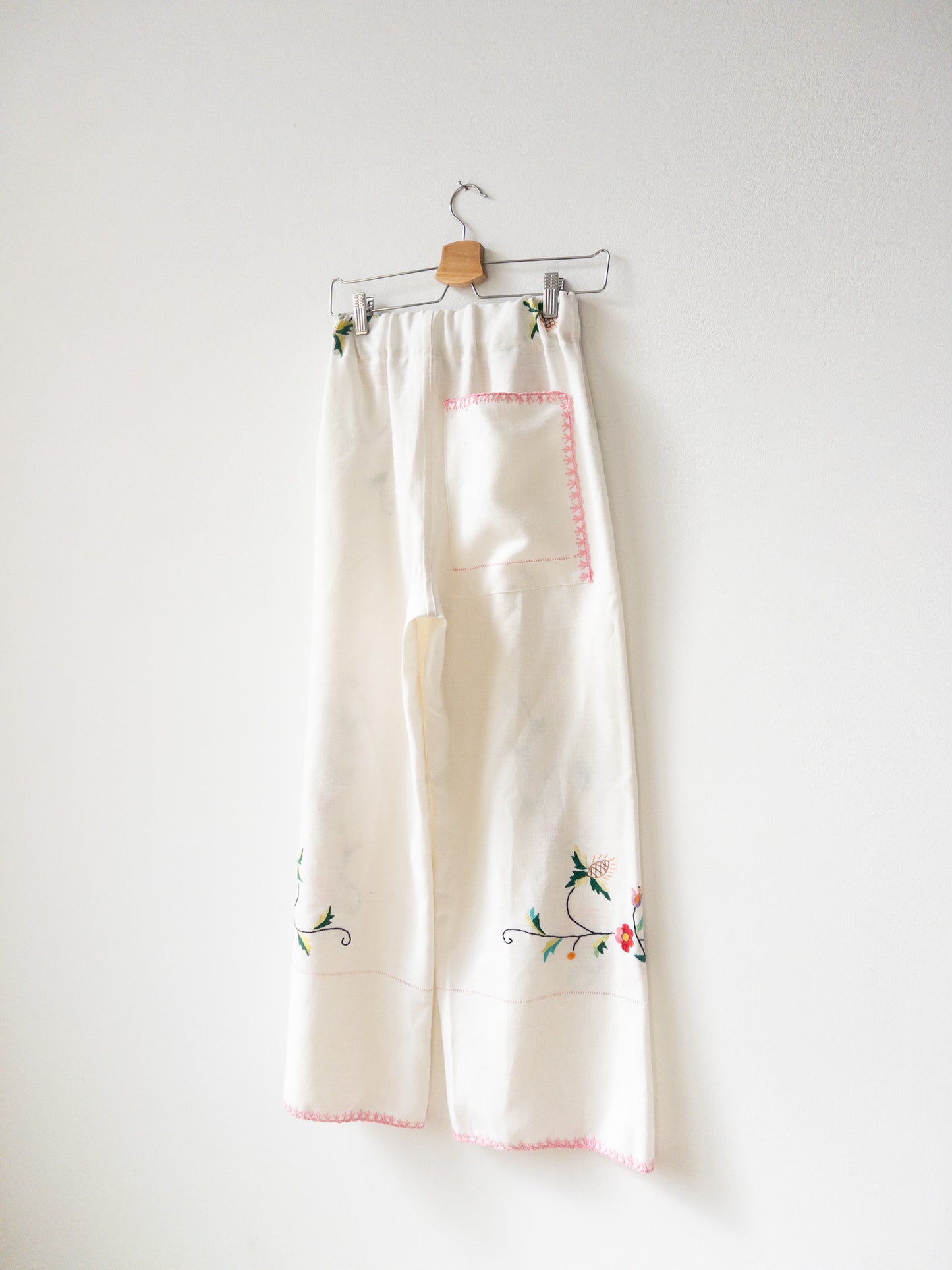 White pants with pink embroidery